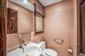 Half bath featuring toilet and a sink