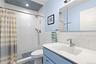 Full bathroom with vanity, tile walls, and a tile shower