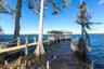 Boat Dock104 Feet Long Wooden Boat Dock23 Ft +/- Boat Lift with a remote dropDual Jet Ski LiftsGazebo with Wooden Table and BenchBuilt In StorageEquip