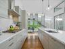 Kitchen with modern cabinets, healthy amount of natural light, decorative backsplash, and recessed lighting