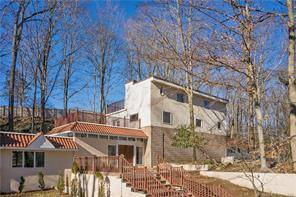 Unique, recently, fully updated home, solidly built designed by, Bauhaus inspired, award winning architect, sits on a private, wooded 1.