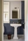 Bathroom featuring tile walls, wainscoting, and marble finish floors