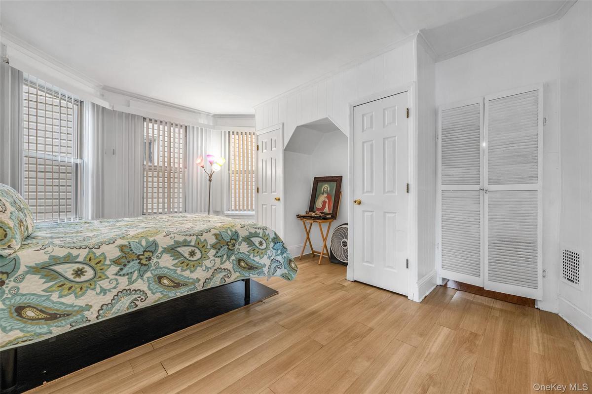 Bedroom featuring crown molding and light wood finished floors