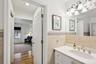 Bathroom featuring vanity, wood-type flooring, and tile walls