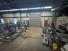 Garage with a heating unit, metal wall, and a workshop area
