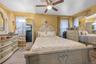 Bedroom with light carpet and ceiling fan