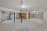 Unfinished below grade area with stairs, water heater, and heating unit