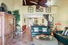 Living Room with Tommy Bahama Themed Decor, Terracotta Tile, High Ceilings, and Spiral Staircase to the Spacious Loft
