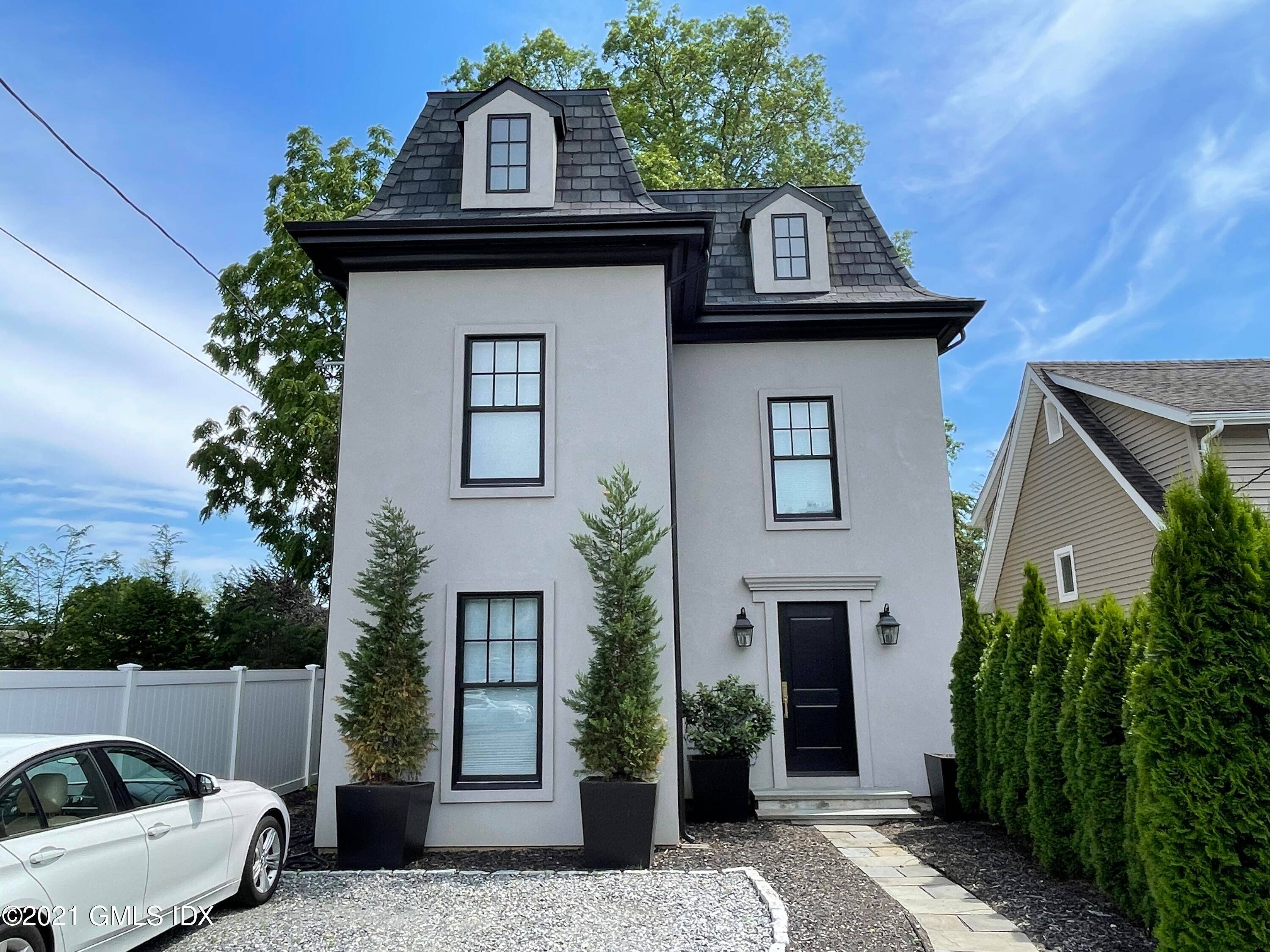 Impeccable, 2019 renovated in town home delivers stylish interior with covered terrace, affording peaceful views and fenced in backyard, feet from Greenwich Ave.