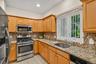 The kitchen has a large window above the sink overlooking the back yard.
