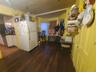 Kitchen with freestanding refrigerator, dark countertops, and dark wood-type flooring