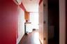 Hallway with a drop ceiling, a wall mounted AC, and hardwood / wood-style flooring