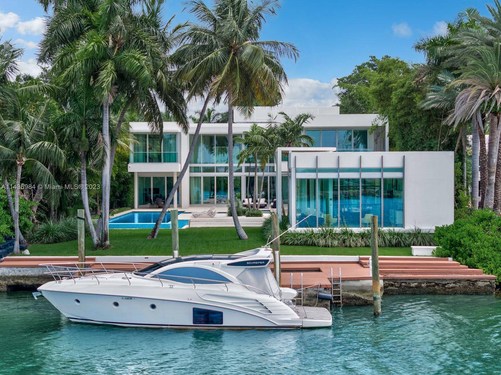In a league of its own, this modern estate redefines luxury living on guard gated Palm Island.