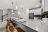 open concept kitchen with stainless steel appliances and counter hieght seating