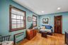 Sitting room with radiator heating unit, light wood-type flooring, and recessed lighting
