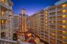 Grand architecture and a warm evening ambiance create a beautiful welcome home.