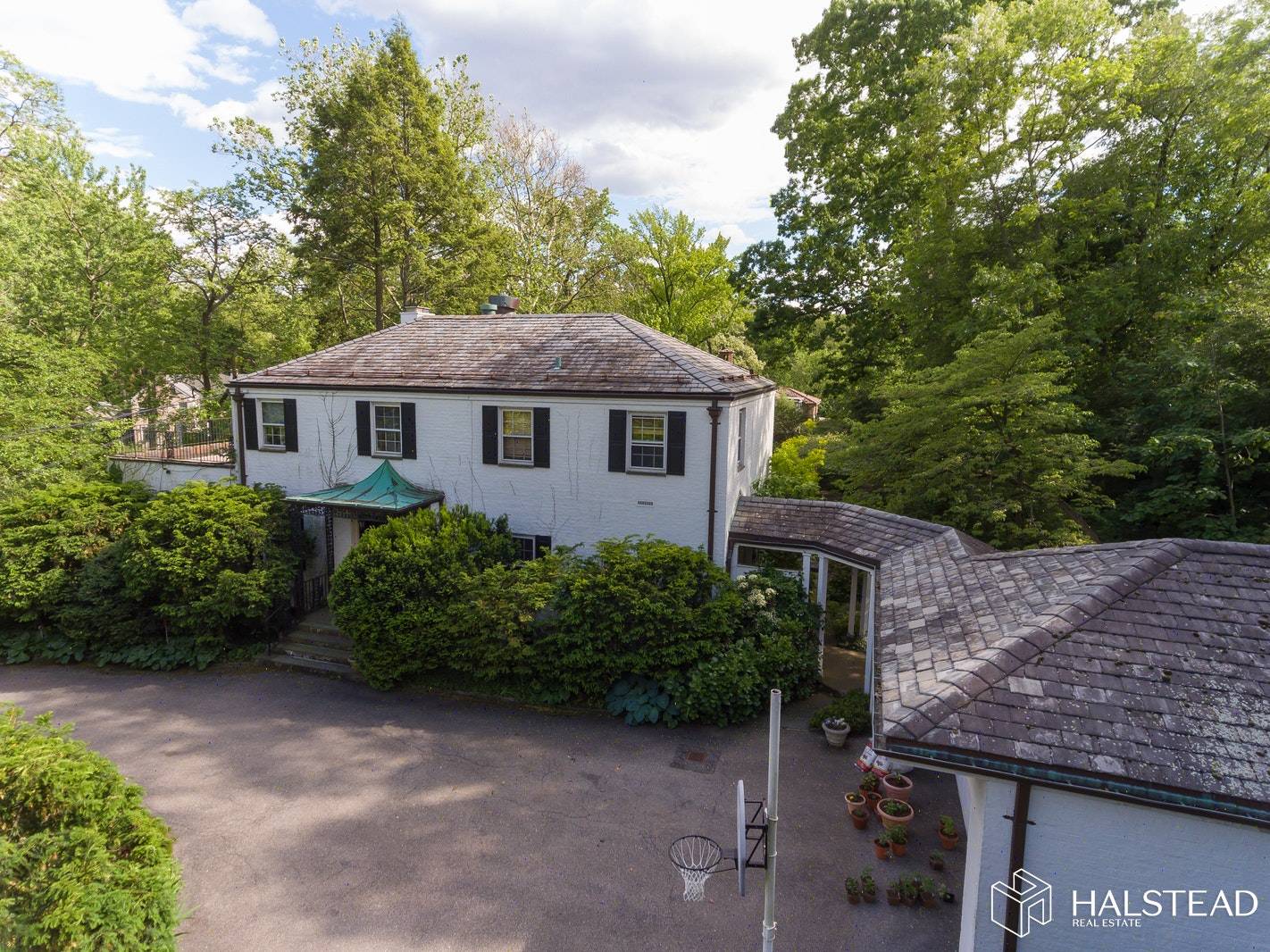 A large Unique Center Hall brick home in a very private and lush setting in the Estate Area of Riverdale.