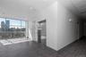 Hallway with elevator, a wall of windows, a city view, baseboards, and recessed lighting