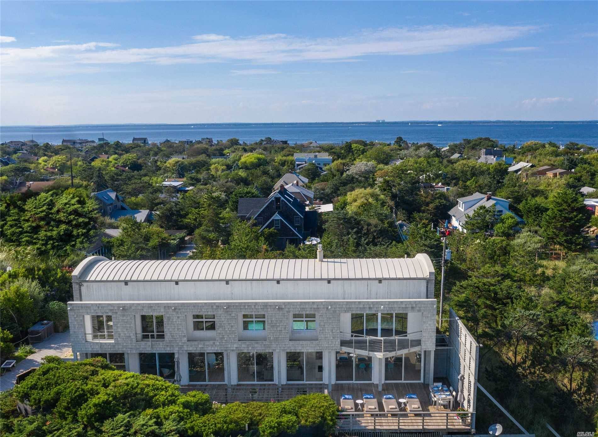 This sun flooded oceanfront compound offers magnificent ocean views from huge picture windows throughout the entire house and transfers with an adjacent lot, offering the option for a guest cottage.