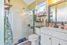 Full bathroom with a shower stall, vanity, and light wood-style flooring