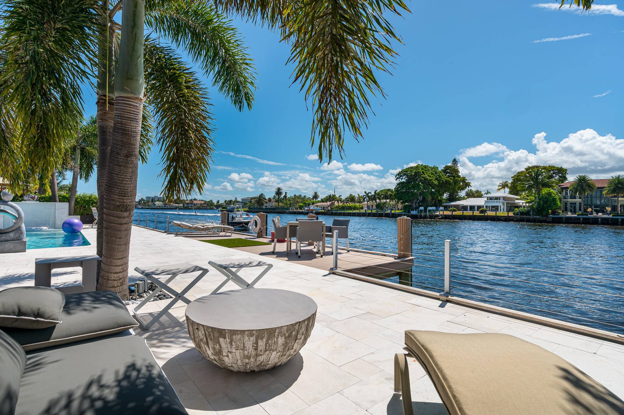 Artistically renovated with clean modern lines, this gated Direct Intracoastal masterpiece on 1 3 of an acre sparkles and delights.