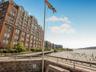 View of apartment building / complex featuring a water view and a view of city