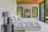 First floor primary bedroom with floor to ceiling windows, access to outdoor terrace, large walk-in closet and en suite bath