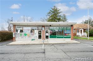 View of commercial property featuring uncovered parking