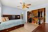 Well-appointed second bedroom featuring abundant natural light and a custom closet organizer designed to maximize storage and keep everything neatly a