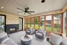 Sunroom / solarium with an outdoor living space with a fireplace and ceiling fan