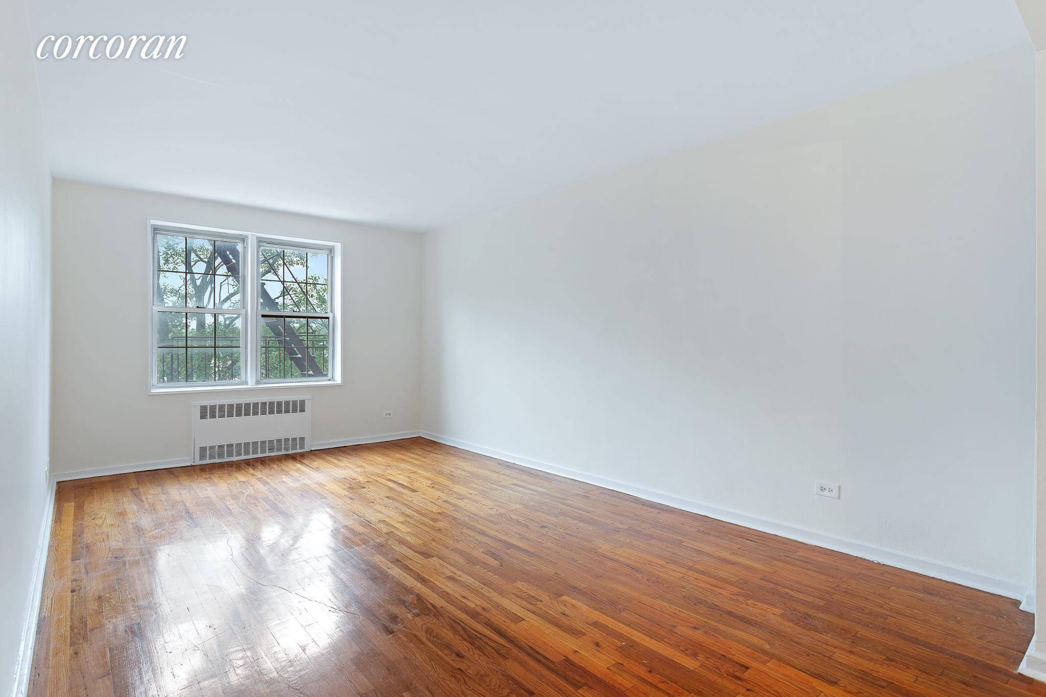 Sunny and Sprawling one bedroom convertible 2BR apartment in a well maintained building on a pretty, tree lined block in vibrant Rego Park.