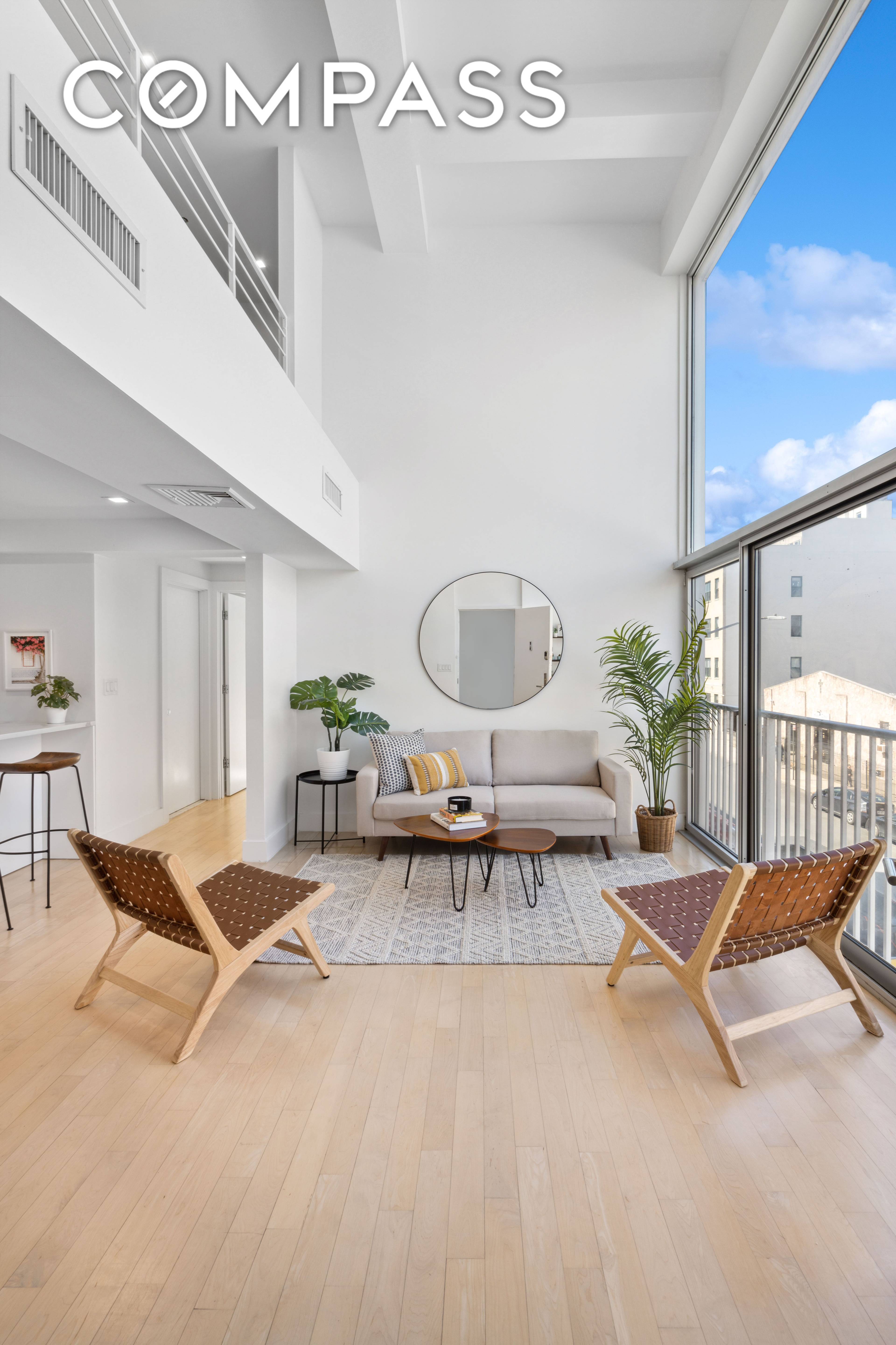 Soaring double height ceilings, dramatic floor to ceiling windows, central HVAC, and private outdoor space are just some of the coveted features that define this modern, loft like home.
