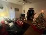 Living area featuring wood finished floors, ceiling fan, and radiator heating unit