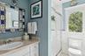 Bathroom featuring a stall shower and vanity