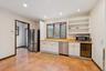 Kitchen with white cabinets, stainless steel appliances, open shelves, recessed lighting, and beverage cooler