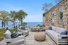 Wooden deck featuring an outdoor living space, a water view, and outdoor dining space