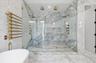 Full bathroom with stone wall, marble tiled flooring, a soaking tub, tile walls, and recessed lighting