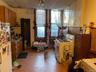 Kitchen featuring brown cabinetry, white appliances, and a drop ceiling