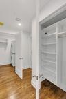 Closet featuring stacked washer/dryer and built-ins