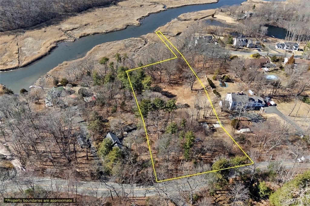 Aerial overview of property's location featuring property boundaries highlighted and a large body of water