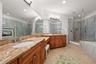 primary bath with double vanities and dressing area