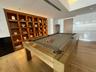 Game room with light wood finished floors and pool table