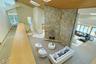 A stunning fieldstone fireplace rises dramatically through the heart of the home, anchoring multiple living areas.