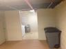 Below grade area with washer / clothes dryer and concrete block wall