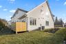 Back of house featuring a yard and a deck