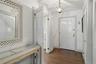 Entryway featuring dark wood-style flooring and a chandelier