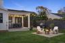 View of yard featuring a wooden deck, a fire pit, and a patio