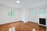 Filled with natural light, this generously sized bedroom offers classic Tudor-style windows, ample closet storage, and a fresh, airy ambiance.