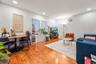 Living area with light wood-style flooring and recessed lighting