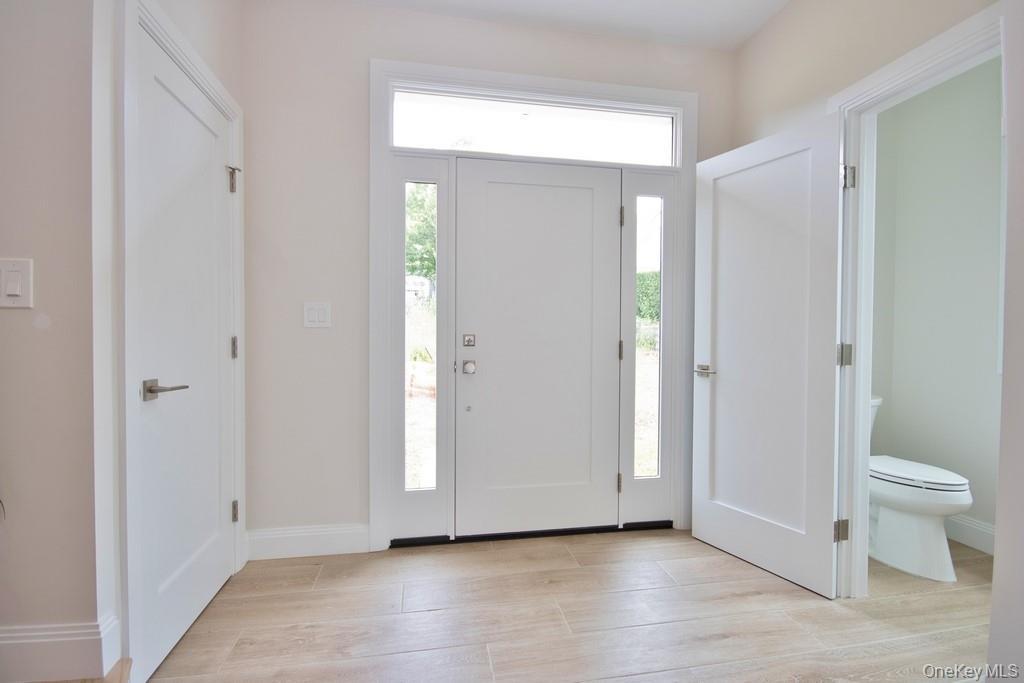 Entryway featuring wood tiled floors and baseboards